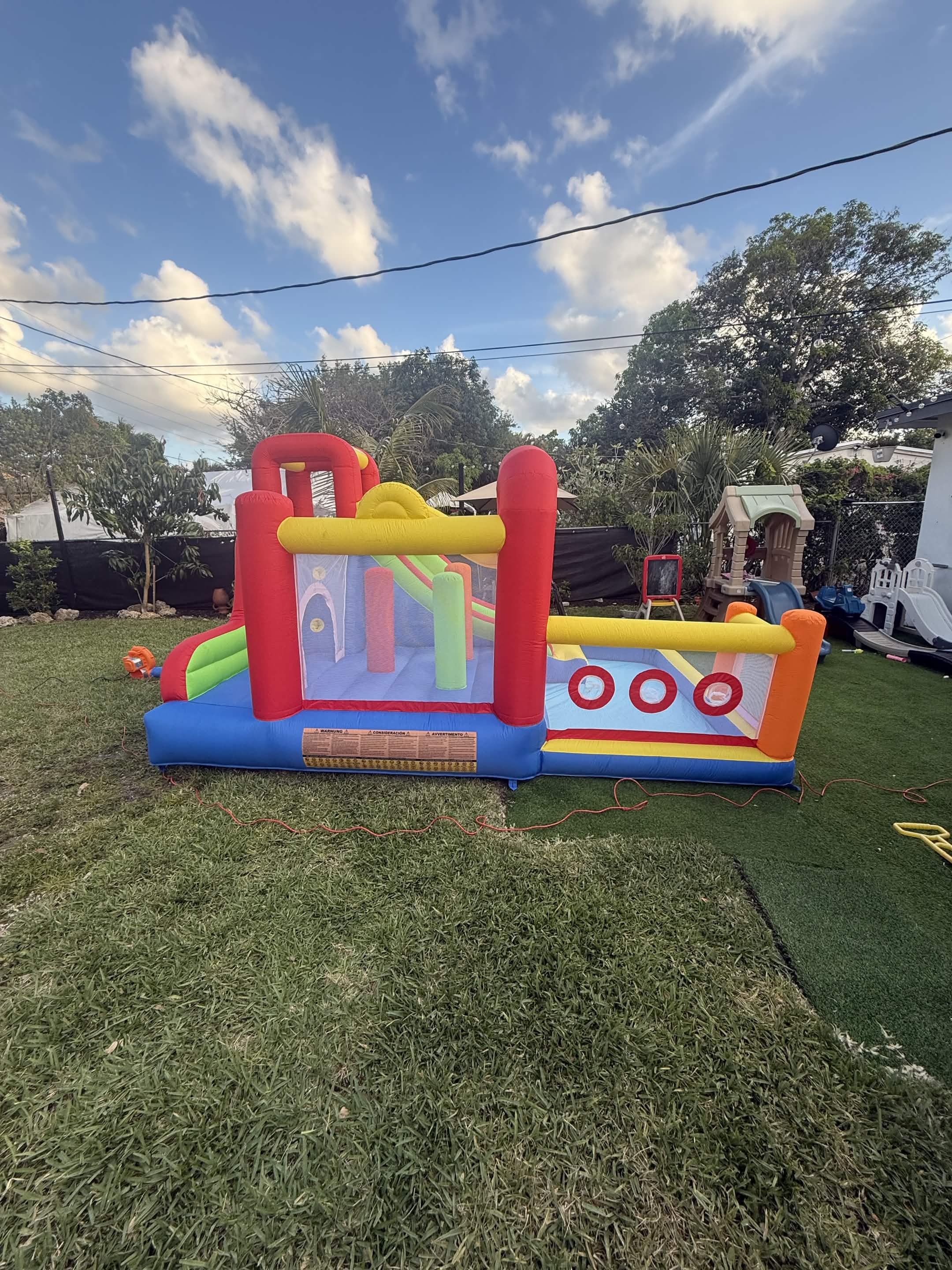 Omnipotent Playhouse bounce house set up for a toddler birthday party in Hollywood Florida